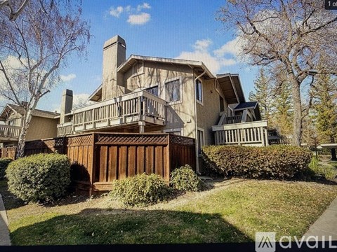 A large house with a balcony and a fence.