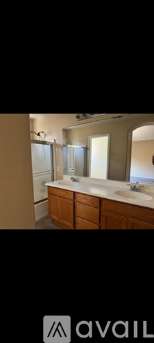 A bathroom with a large mirror and a sink.