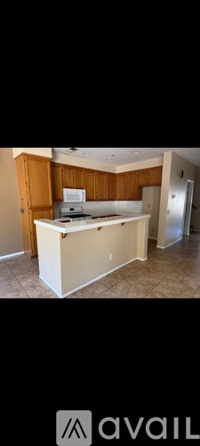 A kitchen with wooden cabinets and a white countertop.