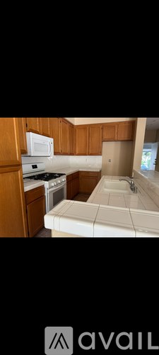 A kitchen with wooden cabinets and a white countertop.