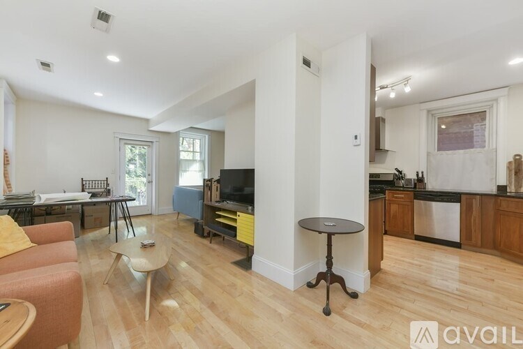 A living room with a sofa, a table, and a television.