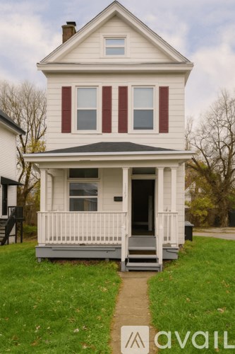 A two-story house with a porch and a front yard.