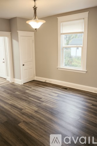 A room with wooden floors and a window.