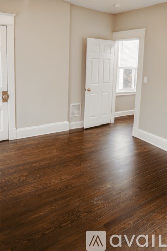 A room with wooden floors and white doors.