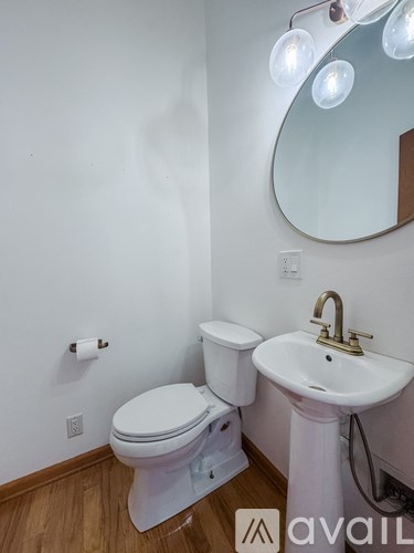 A white toilet and sink in a small bathroom.