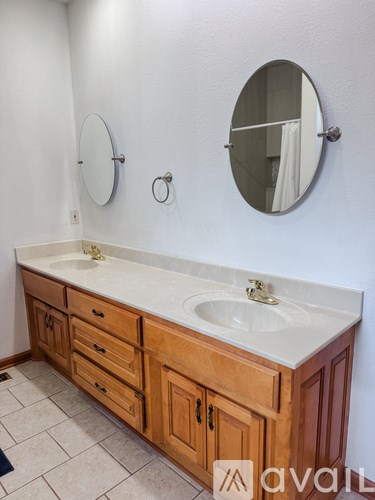A bathroom with a sink and a mirror.