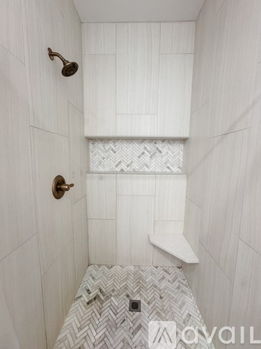 A white bathroom with a shower and a white bench.