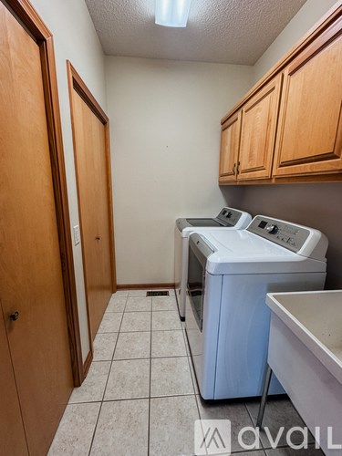 A small laundry room with a washer and dryer.