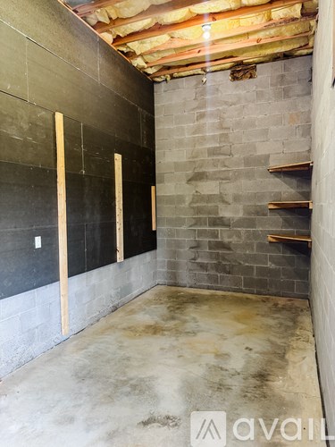 A room under construction with exposed wooden beams.