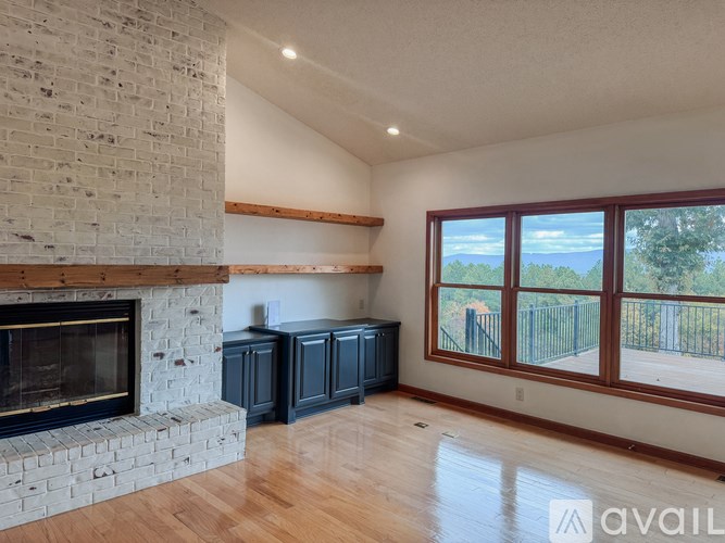 A room with a fireplace and wooden floors.