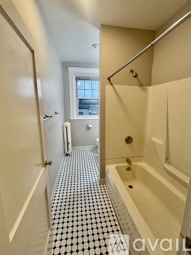 A bathroom with a black and white tiled floor.