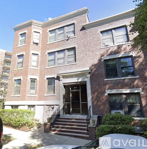A brick building with the number 177 on the door.