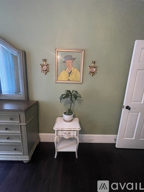 A room with a green wall and a white chair.