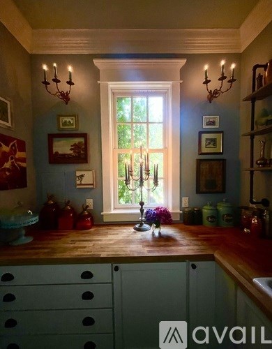 A kitchen with a window and a chandelier.