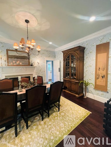 A dining room with a table set for six.