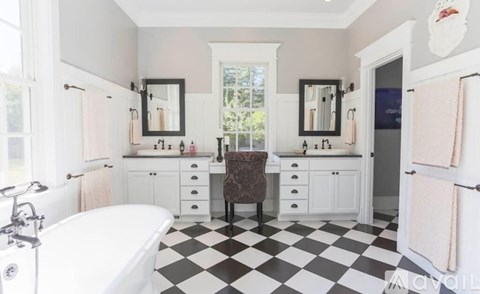 A bathroom with a black and white checkered floor.