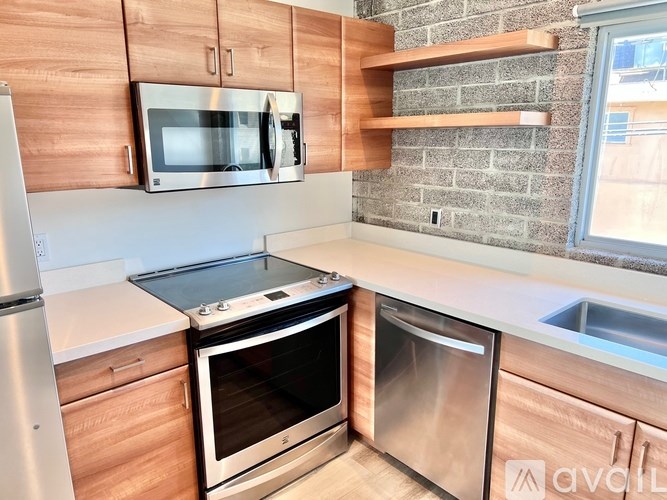 A kitchen with a stove top oven and microwave.
