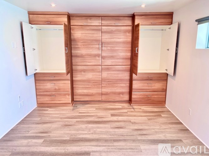 A room with wooden floors and cabinets.