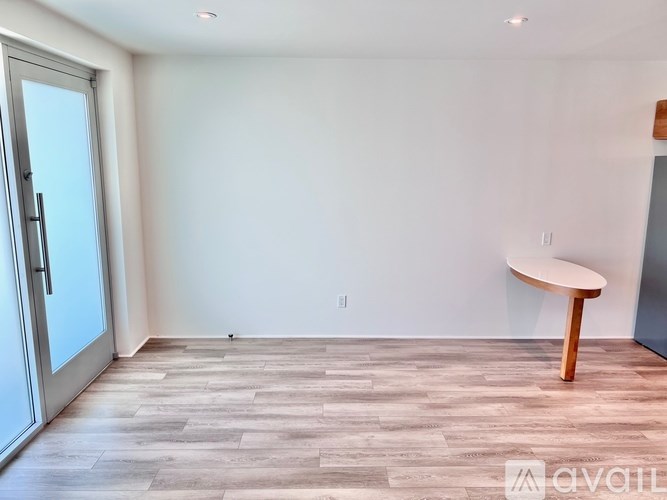 A room with a wooden floor and a round table.