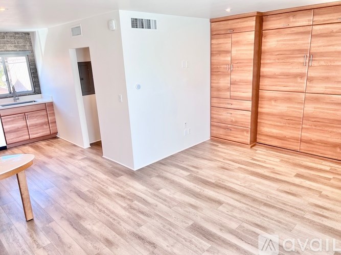 A room with wooden floors and a white door.