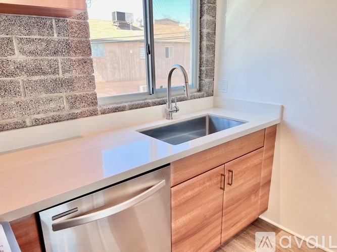 A kitchen with a sink and a window.