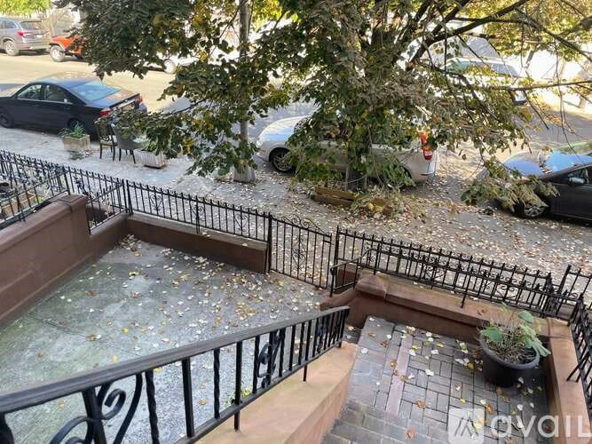 A black metal fence surrounds a small garden area.