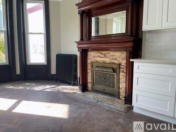A room with a fireplace and a radiator.