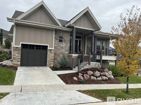 A house with a grey garage door and a grey front door.