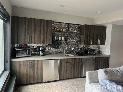 A modern kitchen with wooden cabinets and stainless steel appliances.