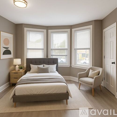 A bedroom with a bed, chair, and window.