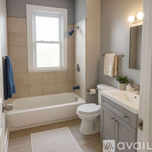 A bathroom with a toilet, sink, and bathtub.