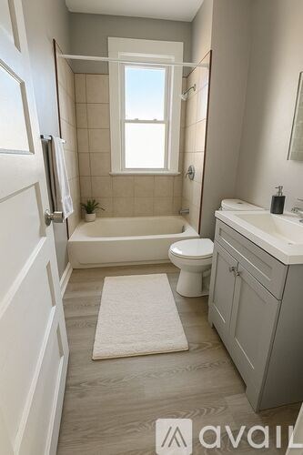 A bathroom with a toilet, sink, and tub.