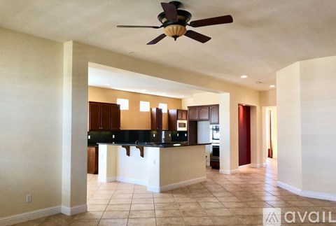 A spacious kitchen with a fan on the ceiling.