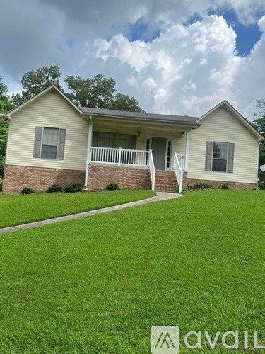 A house with a lawn in front of it.