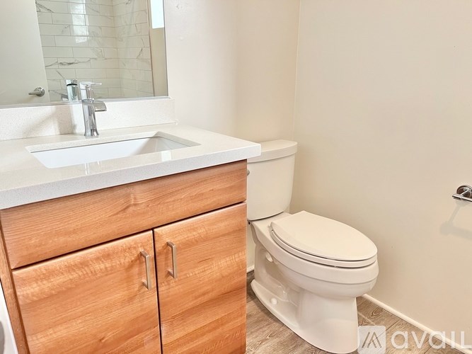 A white toilet sits next to a sink in a bathroom.