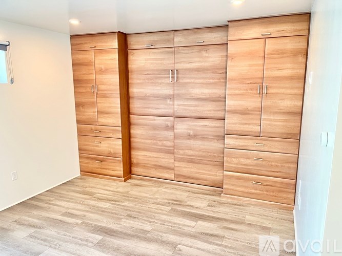 Closet with wood panels and drawers.