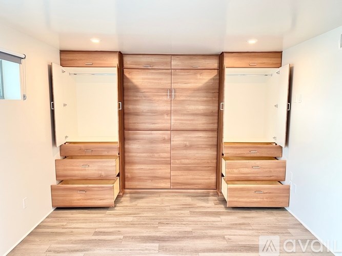 A room with a set of drawers and a wardrobe.