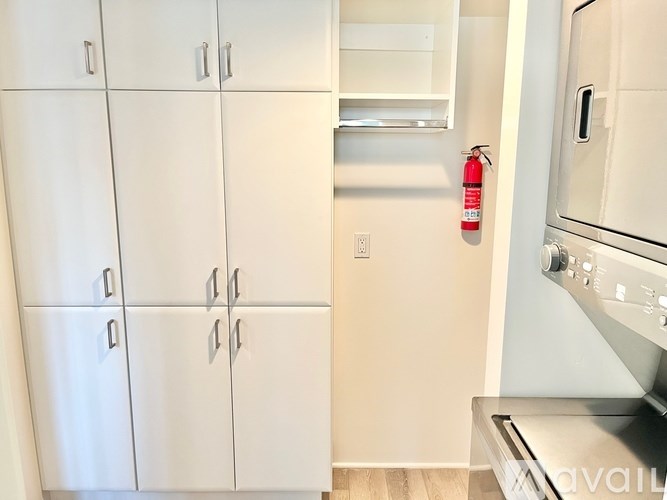 A kitchen with white cabinets and a stainless steel oven.