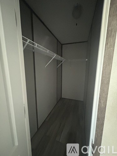 A white closet with a hanger rod.