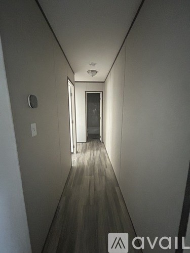 A long hallway with a door at the end.