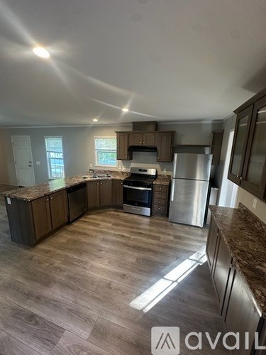 A kitchen with wooden floors and a countertop.