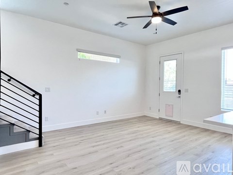 A spacious room with a ceiling fan and a window.