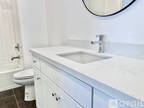 A white bathroom with a toilet and a sink.