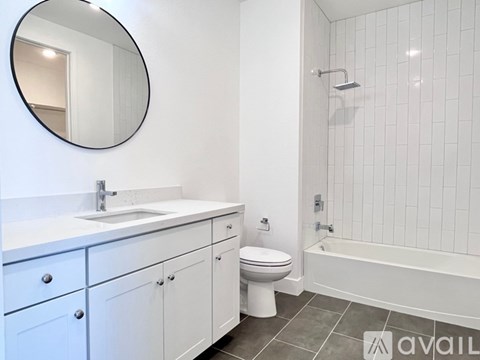 A bathroom with a white sink, toilet, and bathtub.