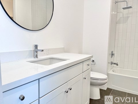 A bathroom with a sink, toilet, and bathtub.