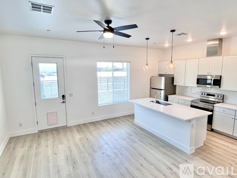 A spacious kitchen with white cabinets and a central island.