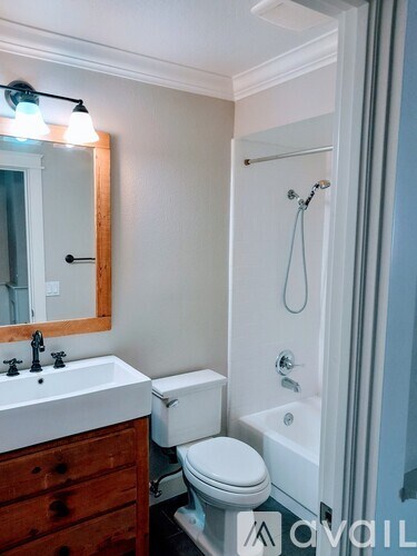 A white toilet sits next to a sink in a bathroom.