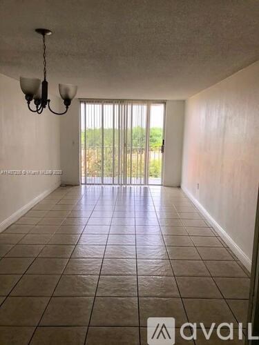A room with tiled flooring and a chandelier.