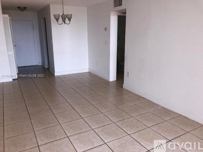 A room with white walls and tiled flooring is available for rent.