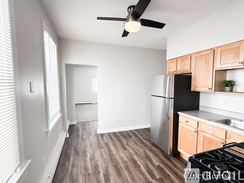 A kitchen with a black stove top oven and a black refrigerator.